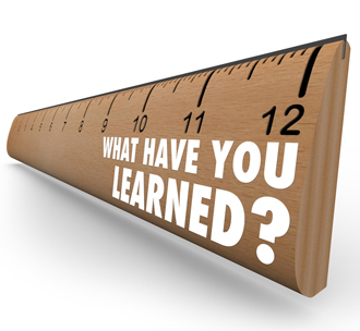 The question What Have You Learned? on a wooden ruler.